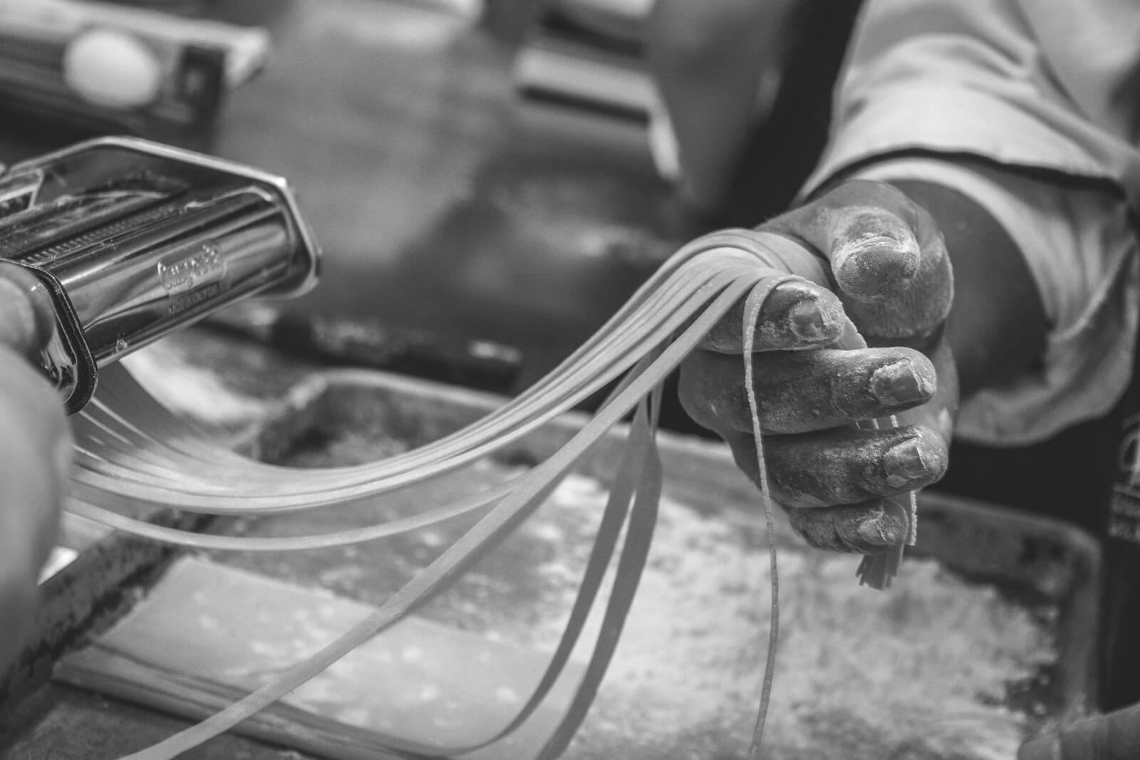 Person Making Tagliatelle Pasta