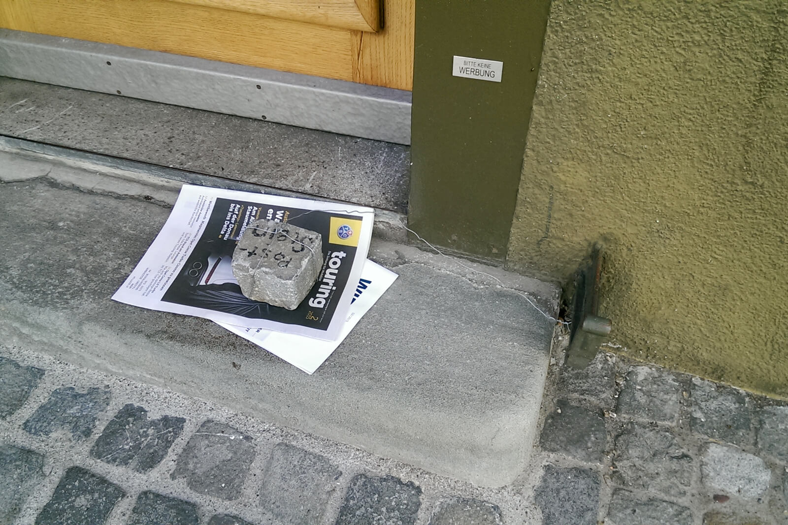 A rock holding down mail in Zug