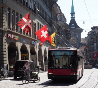 A Swiss flag waving in the Old Town of Bern, Switzerland