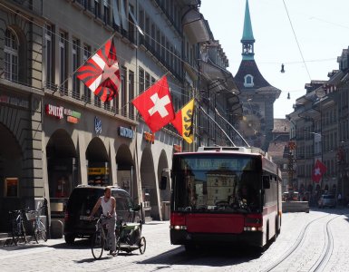 A Swiss flag waving in the Old Town of Bern, Switzerland