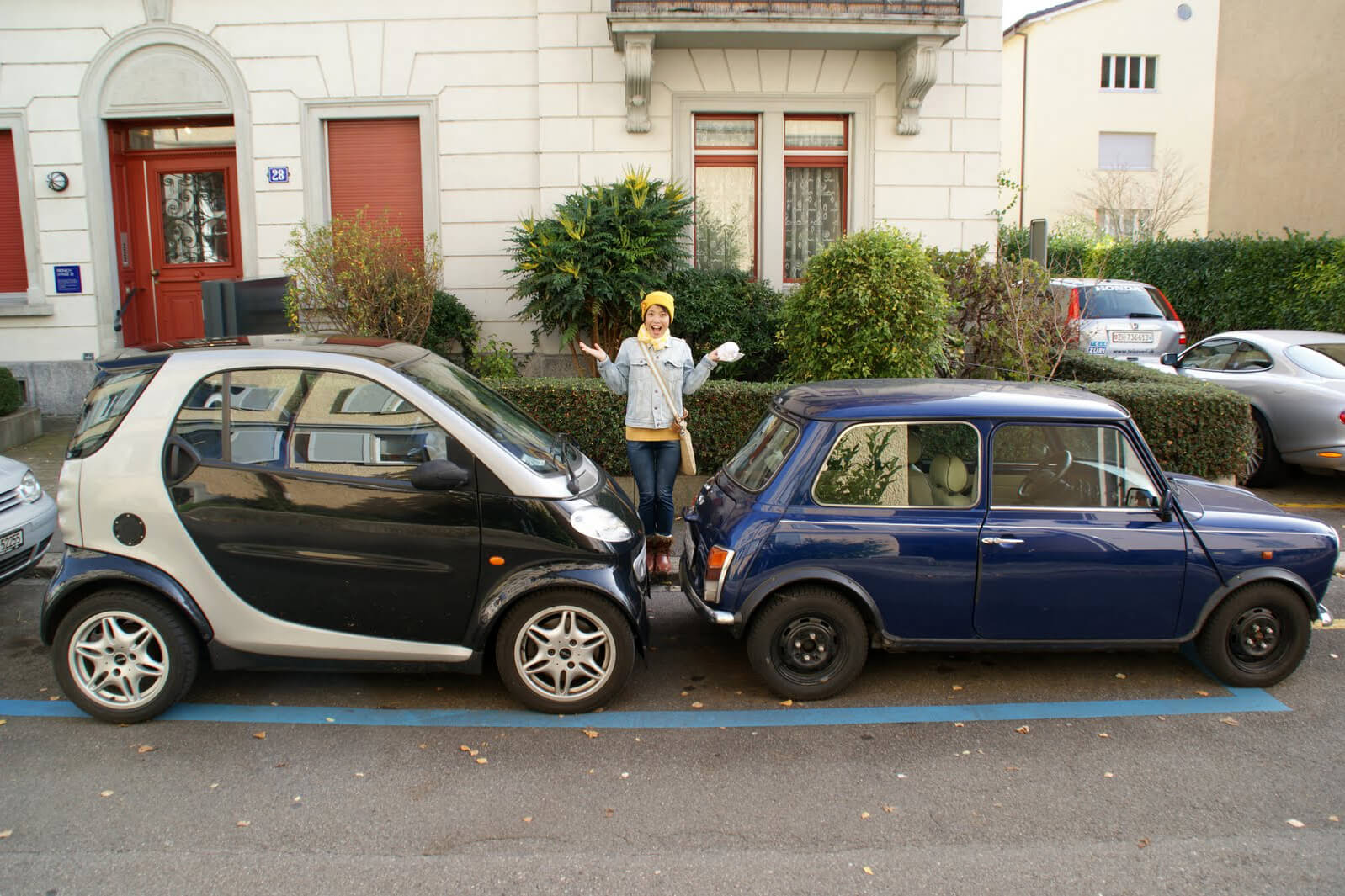 Two small cars parked bumper to bumper in Switzerland