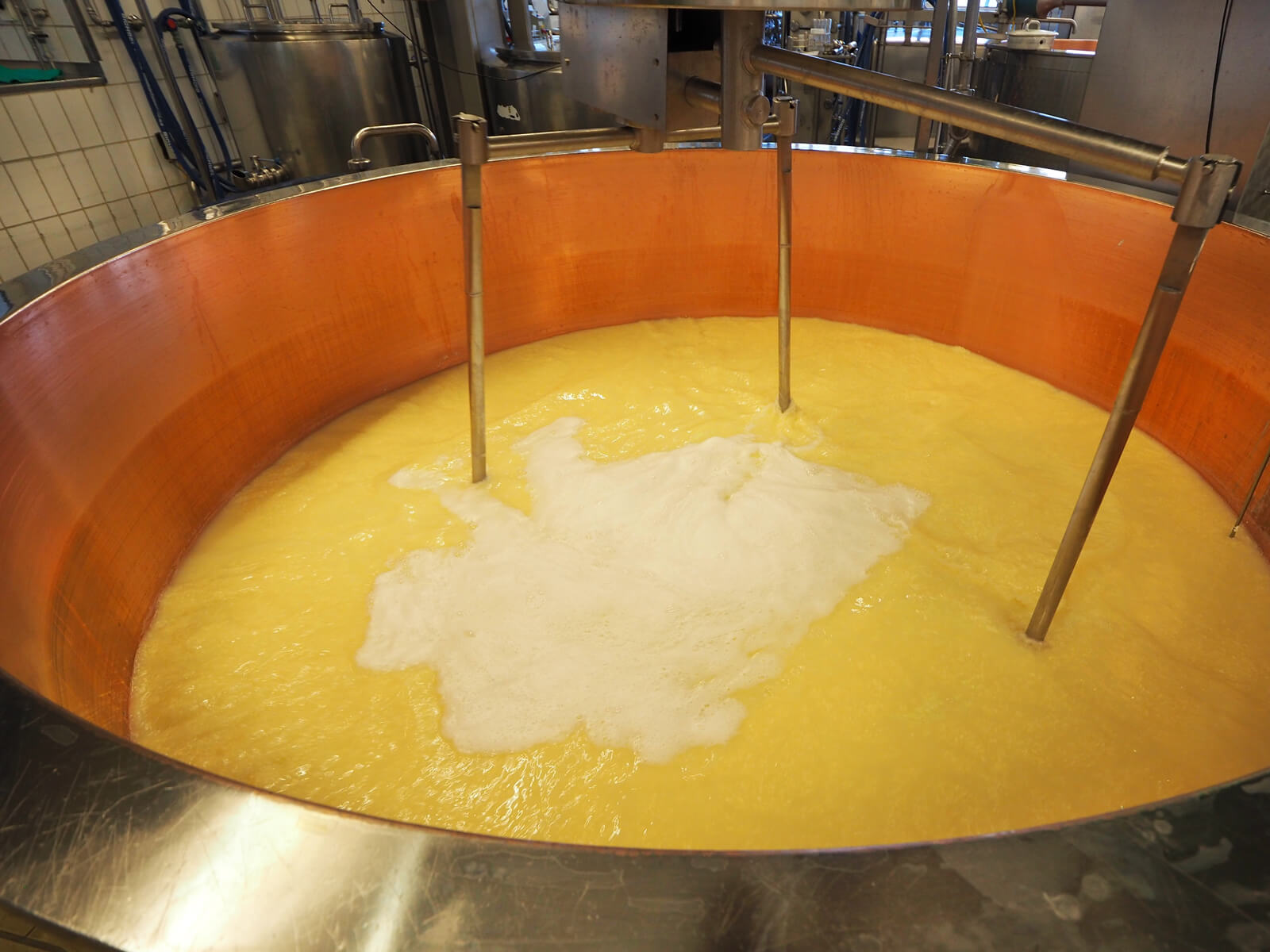 Milk is heated up in a large container at the Emmental Cheese Village
