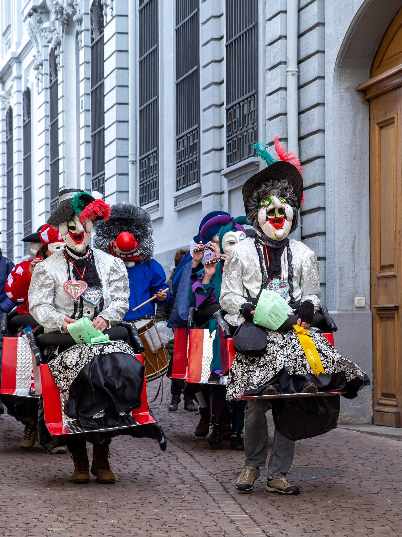 Alti Dame characters walking the old town during the Basel carnival