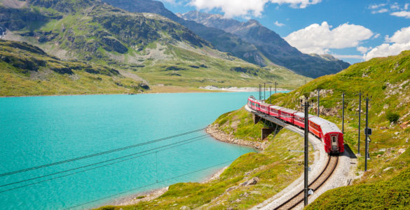 Sustainable Travel in Switzerland - Rhaetian Railways Bernina Express at Lago Bianco showing eco-friendly travel in Switzerland powered by hydroelectric power