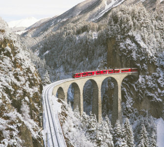 Swiss Travel Pass FAQs - Bernina Express Crossing Landwasser Viaduct in Winter
