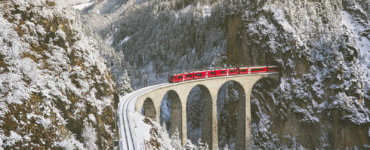 Swiss Travel Pass FAQs - Bernina Express Crossing Landwasser Viaduct in Winter