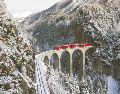 Swiss Travel Pass FAQs - Bernina Express Crossing Landwasser Viaduct in Winter