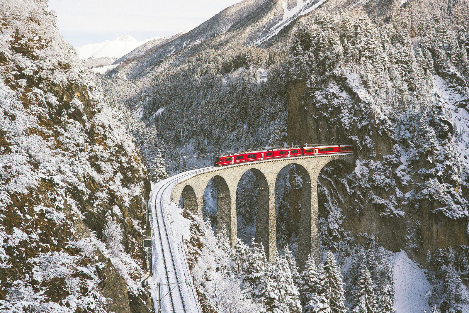 Swiss Travel Pass FAQs - Bernina Express Crossing Landwasser Viaduct in Winter