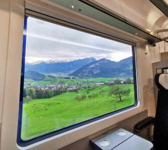 Swiss Travel Pass Price 2024 - Looking out from a train window into the Switzerland landscape