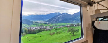 Swiss Travel Pass Price 2024 - Looking out from a train window into the Switzerland landscape