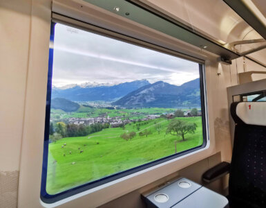 Swiss Travel Pass Price 2024 - Looking out from a train window into the Switzerland landscape