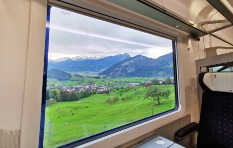 Swiss Travel Pass Price 2024 - Looking out from a train window into the Switzerland landscape