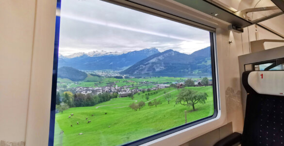 Swiss Travel Pass Price 2024 - Looking out from a train window into the Switzerland landscape