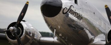 Vintage Swissair Posters - A classic Swissair aircraft featuring twin propellers on a cloudy day in Cambridgeshire.